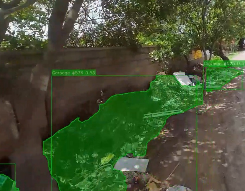 The tagged capture: a garbage pile along a wall, outlined by the model
